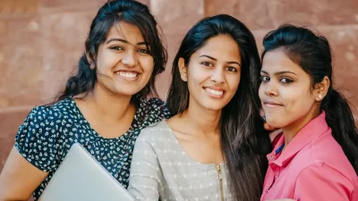 Three girls smiling and posing, excited about their study abroad journey.